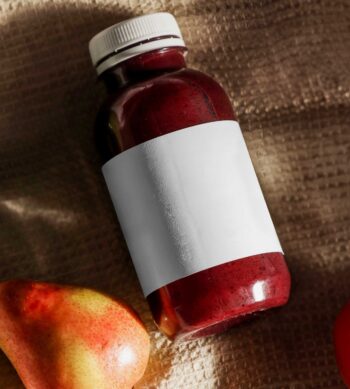 3d mockup free of juice bottle laid down on a cloth